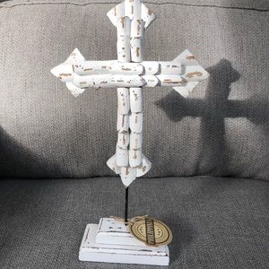 Handcrafted whitewashed wood cross on a metal rod